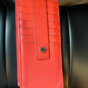Women’s Danier genuine leather credit card holder in a pink/peach colour.